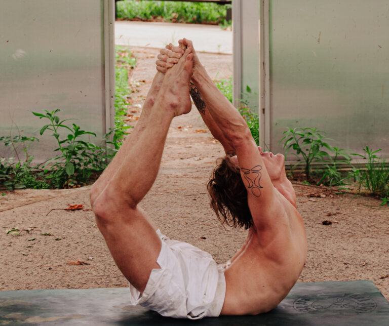 A serene yoga practitioner performing a meditative pose on a scenic outdoor platform overlooking lush green mountains, with soft sunlight filtering through the trees.